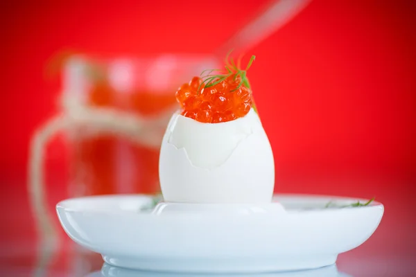 Boiled egg with red caviar — Stock Photo, Image