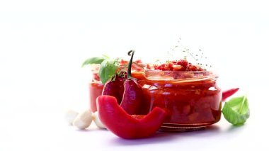 Spicy homemade condiment with red chili and green herbs.
