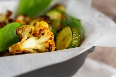 Baked vegetables with golden crust in parchment paper.