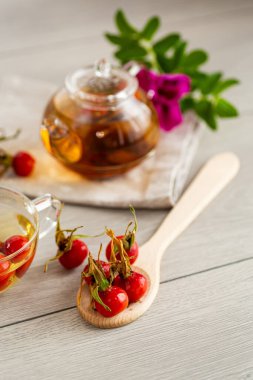 Tahta bir masada, bir fincanda tıbbi gül çayı..
