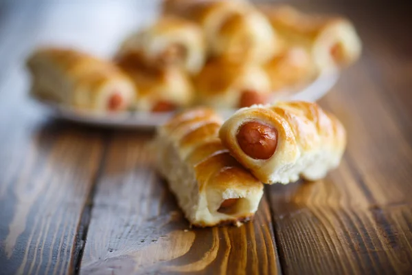 Sausage baked in dough — Stock Photo, Image