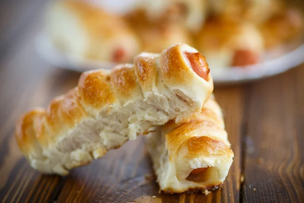 Sausage baked in dough — Stock Photo, Image