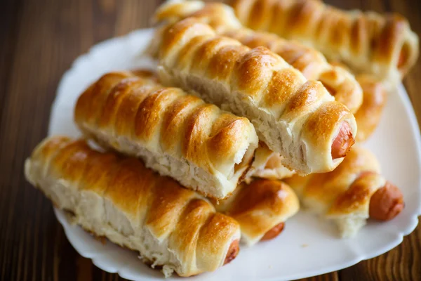Sausage baked in dough — Stock Photo, Image