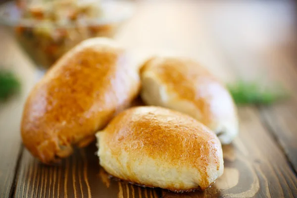 Homemade pies with cabbage and sauerkraut — Stock Photo, Image