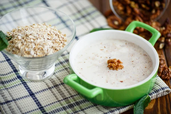Milk oatmeal with walnuts — Stock Photo, Image