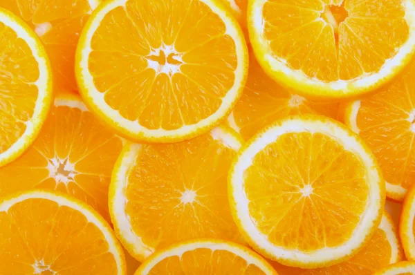 Citrus background. juicy slices of  orange cover the entire surface. — Stock Photo, Image