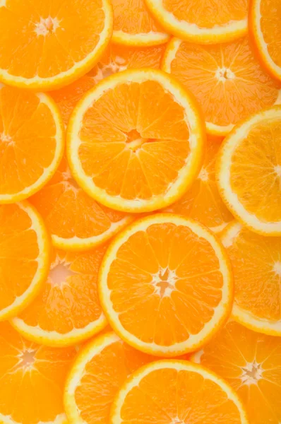 Citrus background. juicy slices of  orange cover the entire surface. — Stock Photo, Image