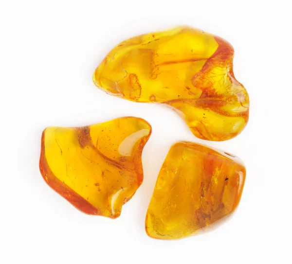 Amber gemstone on white. Soft focus, photo toned — Stock Photo, Image