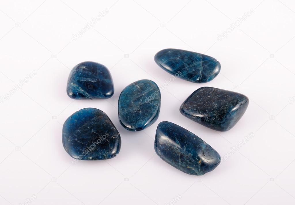 deep blue Apatite gemstone on white. photo toned