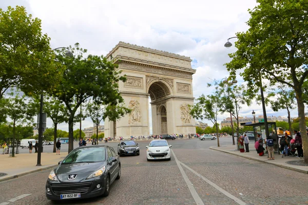Tourists stroll at Champs-Elysees street and the Arc de Triomphe — Stock Photo, Image
