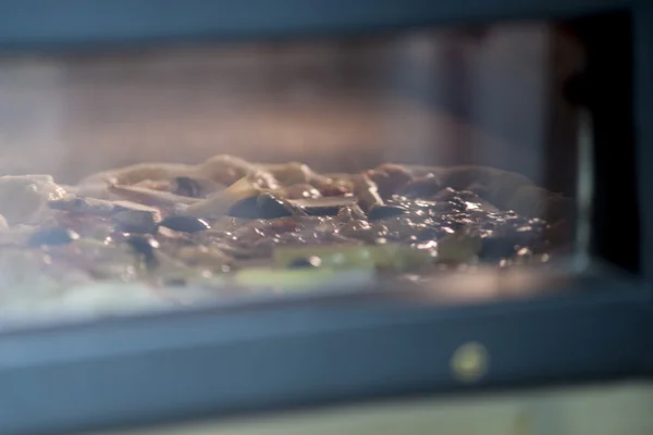 Pizza baking in the oven — Stock Photo, Image