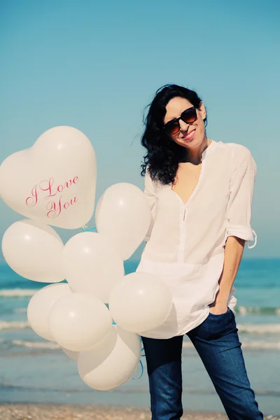 Woman holding white balloons — Stock Photo, Image