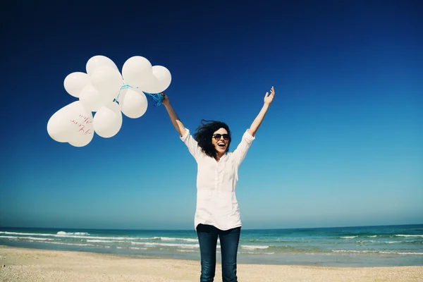 Woman holding white balloons Stock Image