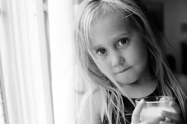 Flicka anläggning glas mjölk — Stockfoto