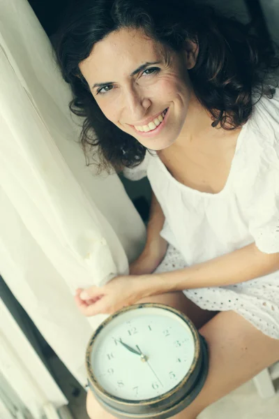 Woman holding clock — Stock Photo, Image