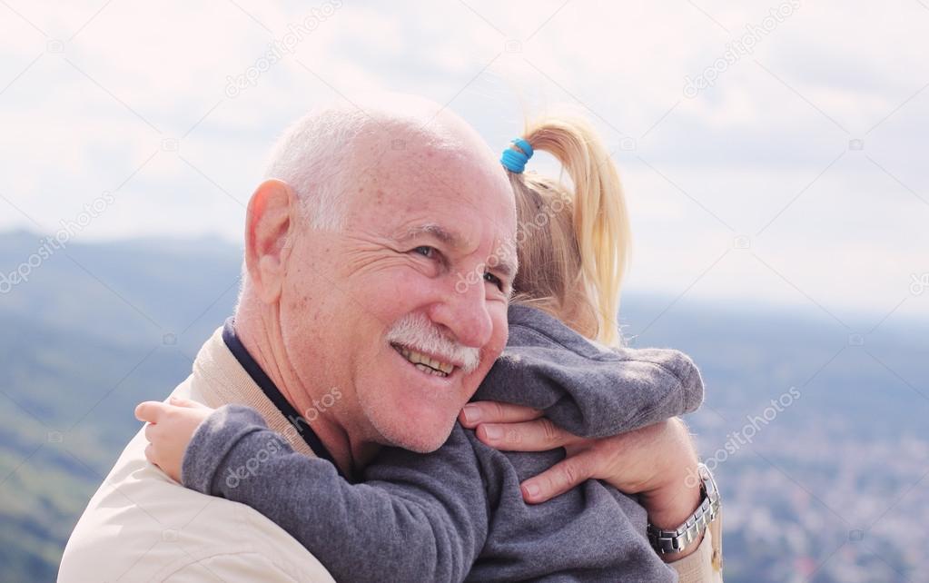 Grandfather holding his  granddaughter
