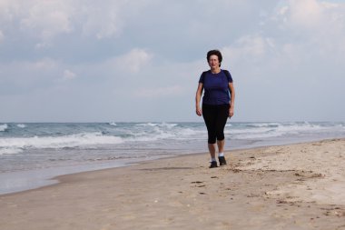 Kumsalda koşan kadın