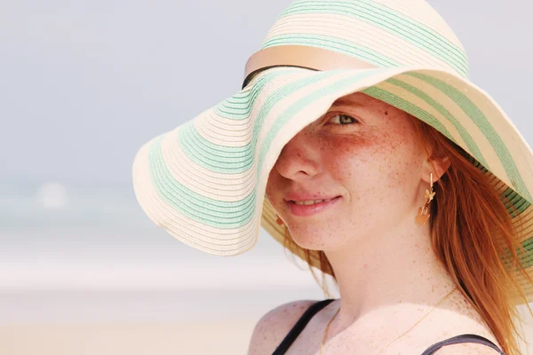 Beautiful young redhead girl in hat — Stock Photo, Image