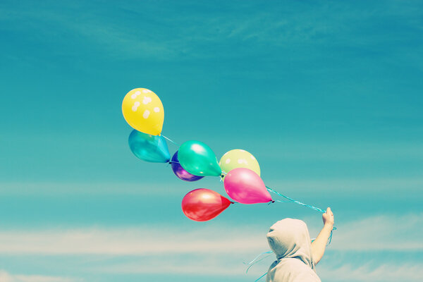 Man holding colorful balloons