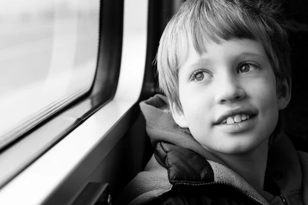 Boy looking through window — Stock Photo, Image