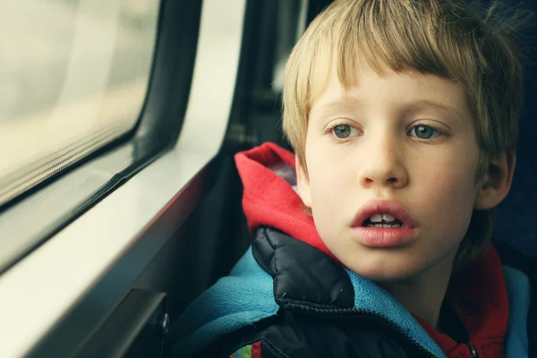 Boy looking through window — Stock Photo, Image