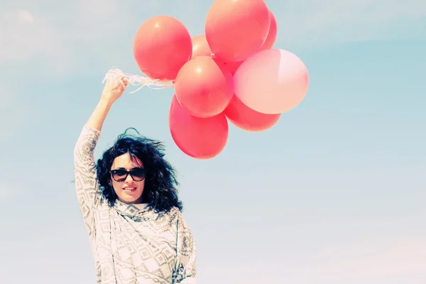 Woman holding balloons — Stock Photo, Image