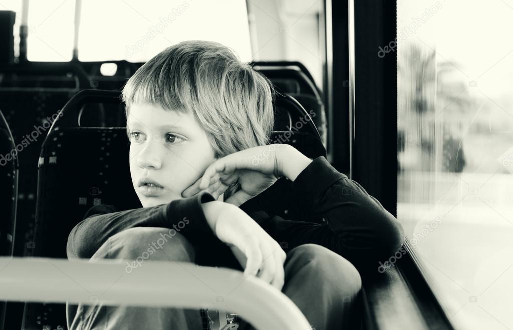 Boy sitting in empty bus