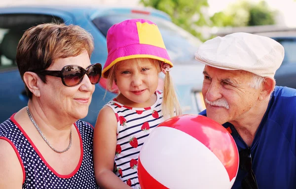 Grandparents with granddaughter outdoors — Stock Photo, Image