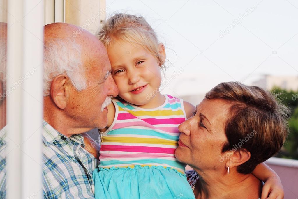 Grandparents holding  granddaughter
