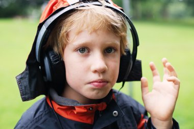 cute autistic boy with headphones clipart