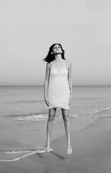 Woman jumping up on the shore — Stock Photo, Image