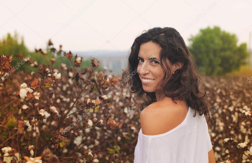 Smiling woman in cotton field