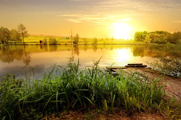 Yellow sunset on pond — Stock Photo, Image