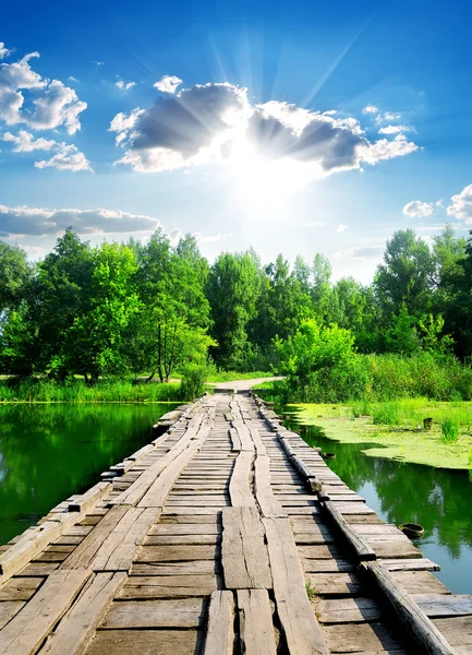 Sun over wooden bridge — Stock Photo, Image