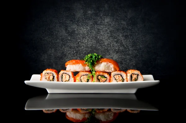 Sushi and rolls in plate — Stock Photo, Image
