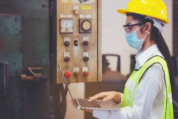 Industrial factory maintenance engineers woman inspect relay protection system of machinery and holding notebook with copy space. Industry, Maintenance, Engineering and construction concept.
