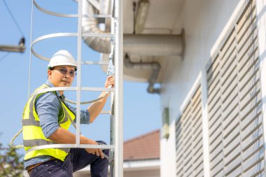 Genç adam işçi ya da mühendis merdiveni tırman.