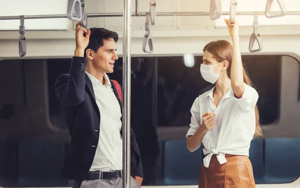 People on the train wear anti-virus masks and travel during rush hours. passengers inside the Sky Train with the masks on all people\'s faces.