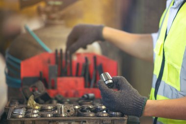 Asian engineer worker quality control of service machine in factory