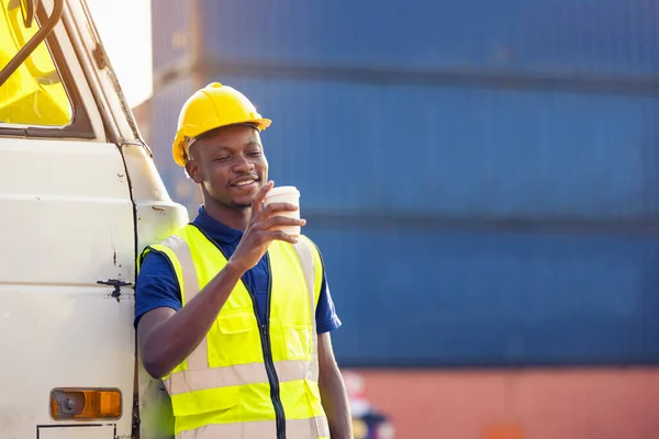 African American businessman drinking coffee, black man have coffee break at worksite outdoors container background