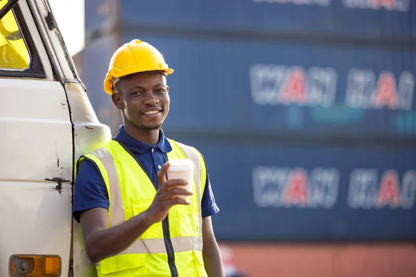 African American businessman drinking coffee, black man have coffee break at worksite outdoors container background