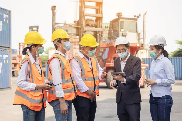 Architect of engineer and dock worker staff working checking at Container cargo harbor holding computer laptop. Business logistic commercial intermodal freight transport in import export, Cargo ship.