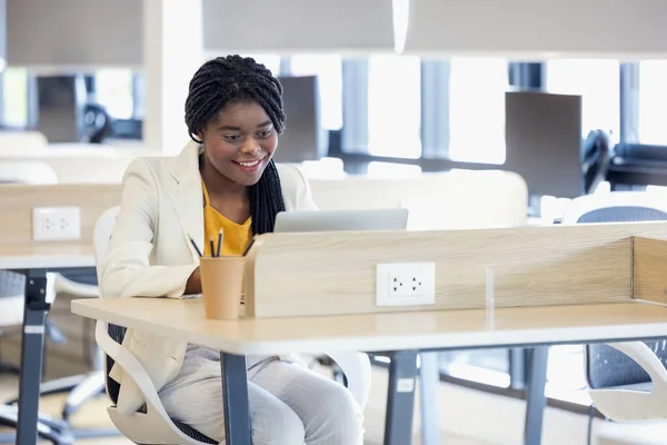 Focused young african american student looking at laptop, Young beautiful black student girl working, learning in college library