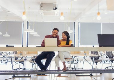 african college university students using laptop together .	