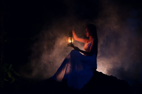 By lighting a lantern in the dark wilderness, a beautiful young woman with a candle gets nothing.