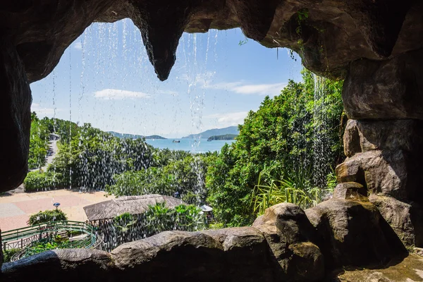 Cave with a waterfall on island — Stock Photo, Image