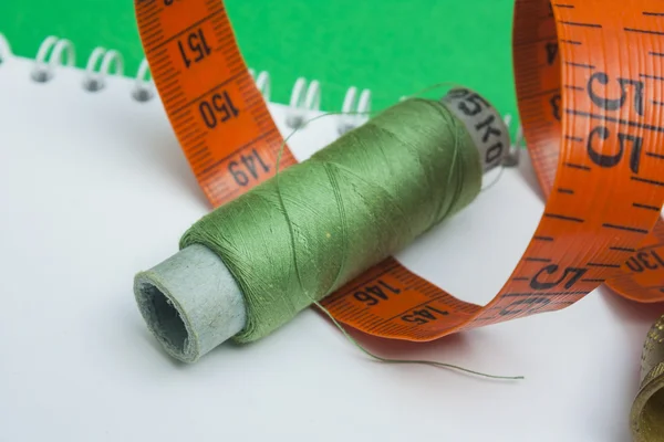 Thread with a needle and buttons — Stock Photo, Image
