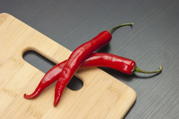 Two red chili peppers — Stok fotoğraf