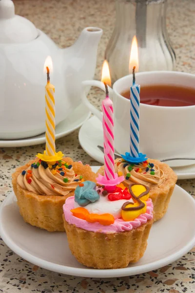 cake with a candle and tea drinking