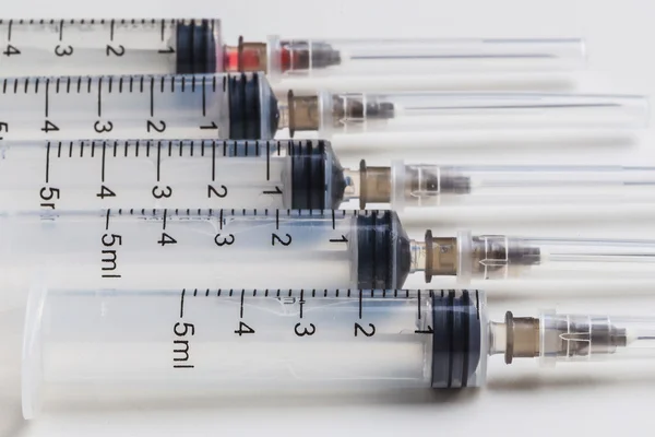 Disposable syringe in row — Stock Photo, Image